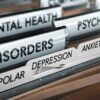 File folders labeled with mental health disorders and psychiatry.