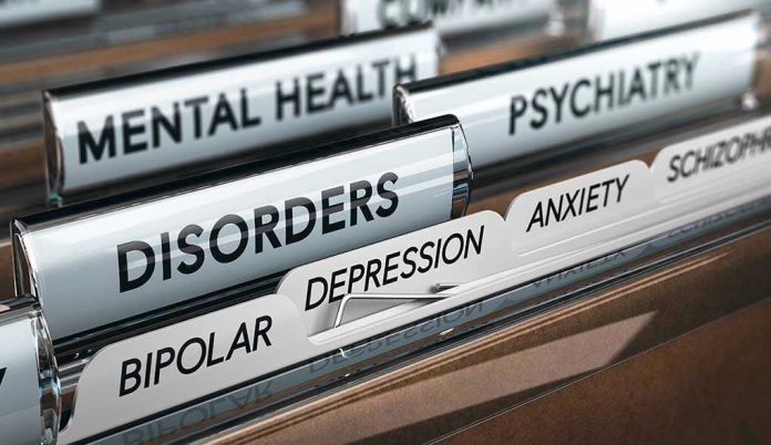 File folders labeled with mental health disorders and psychiatry.