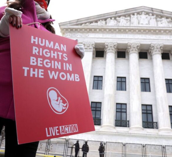 WASHINGTON, DC - JANUARY 29: A pro-life activist holds a sign outside the U.S. Supreme Court during the 48th annual March for Life January 29, 2021 in Washington, DC. Due to the COVID-19 pandemic, a much smaller group of activists participated in the annual march that marked the 1973 Roe v. Wade ruling by the U.S. Supreme Court that had legalized abortion. (Photo by Alex Wong/Getty Images)