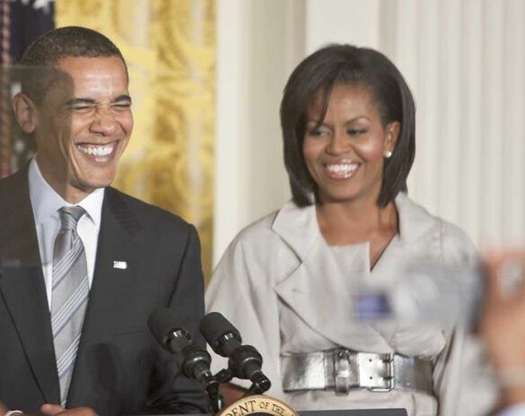 Former President Barack Obama and Michelle Obama smiling at a public event