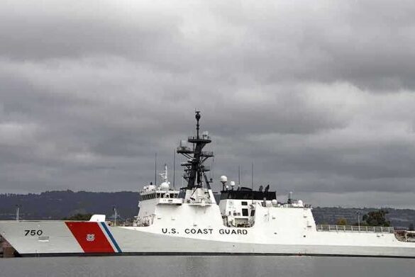 A U.S. Coast Guard ship docked under cloudy skies