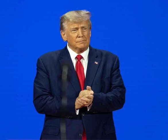 Man in a suit with a blue background.