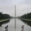 People stand near the Lincoln Memorial Reflecting Pool after a rainstorm in Washington DC, on May 28, 2025. (Photo by ALEX WROBLEWSKI / AFP) (Photo by ALEX WROBLEWSKI/AFP via Getty Images)