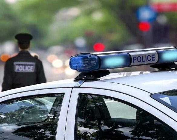 Police car and officer on a city street.