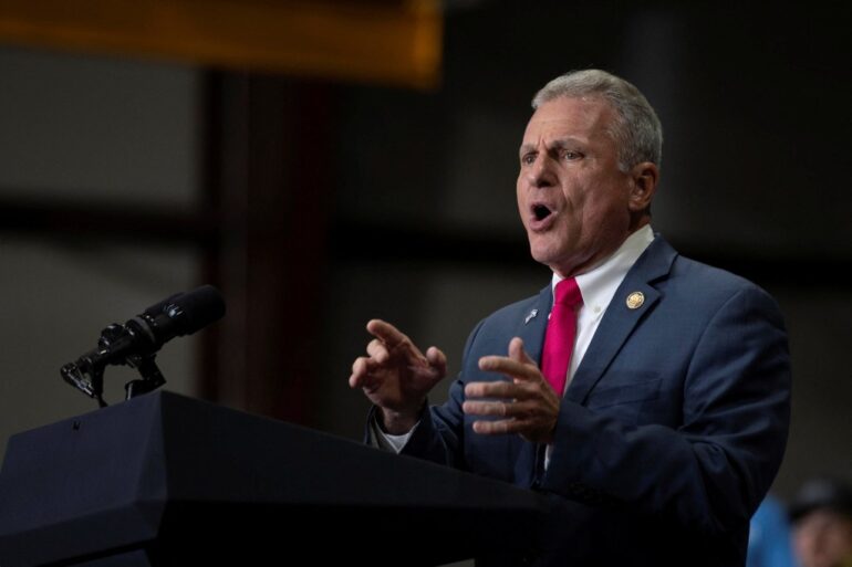 U.S. Representative Buddy Carter (R-GA) speaking at a Republican political event.