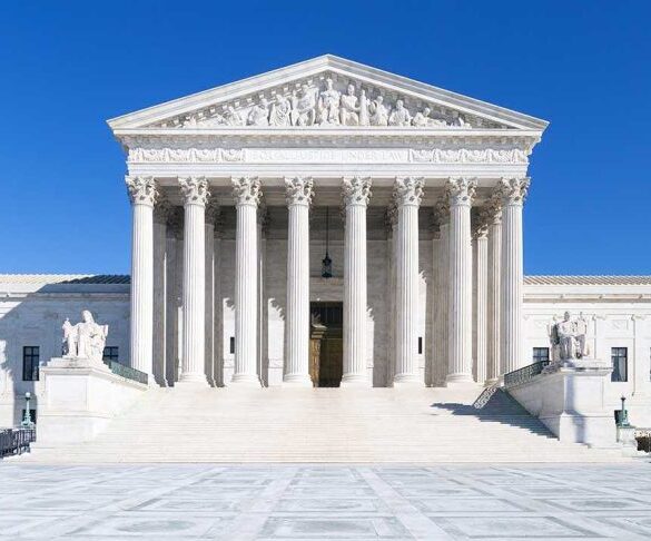 The Supreme Court building featuring marble columns and a clear blue sky