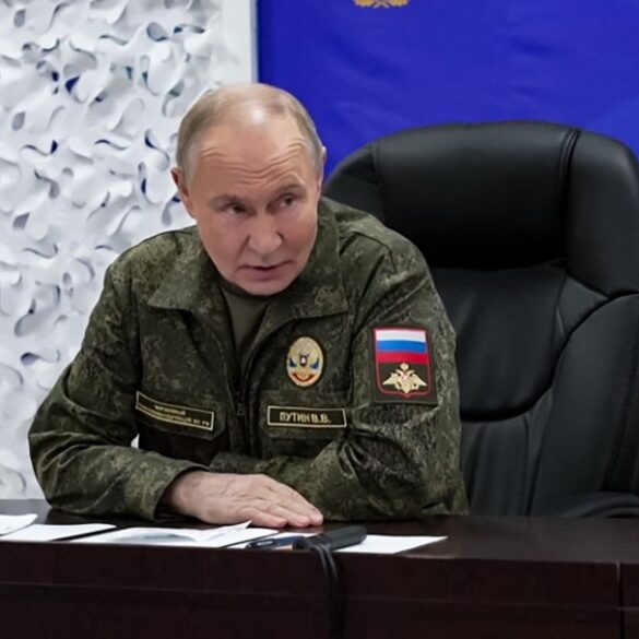 President Vladimir Putin in military uniform at a command post during the Russia-Ukraine conflict.
