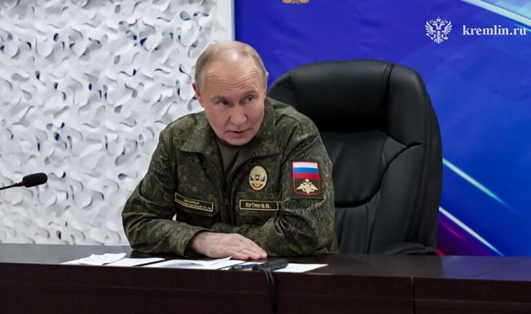 President Vladimir Putin in military uniform at a command post during the Russia-Ukraine conflict.