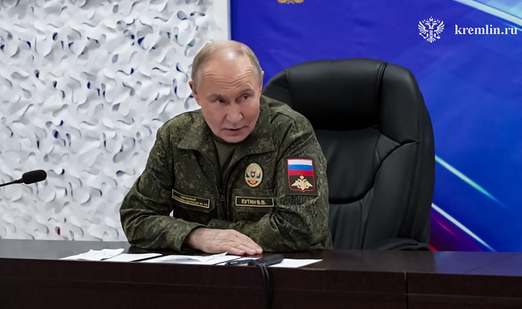 President Vladimir Putin in military uniform at a command post during the Russia-Ukraine conflict.