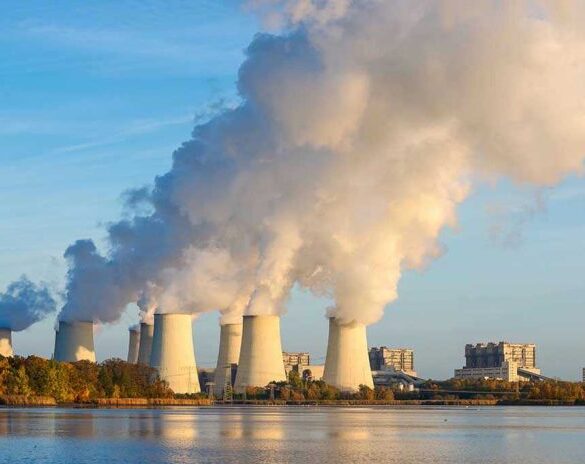 Nuclear power plant cooling towers emitting steam.