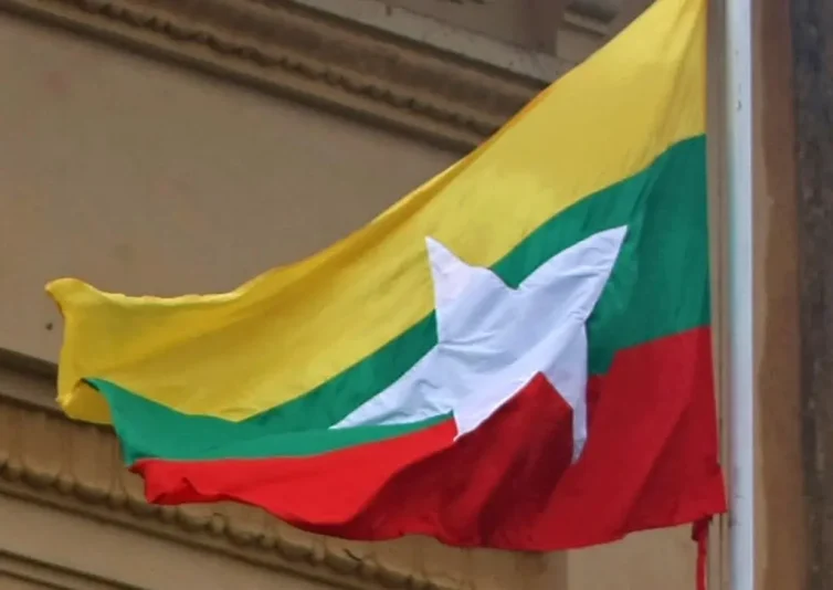 Myamar's new national flag flutters at Yangon City Hall on October 21, 2010. Myanmar's junta began using the new national flag as it gears up for a rare election next month that critics say is a charade aimed at putting a civilian facade on military rule. AFP PHOTO/Soe Than Win (Photo by Soe Than WIN / AFP) (Photo by SOE THAN WIN/AFP via Getty Images)