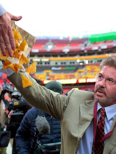 Satire news: dan snyder walking around commanders stadium knocking food