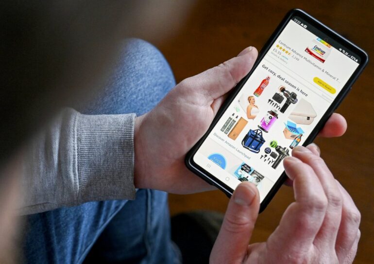 A person viewing a variety of products on the Amazon app on their phone.