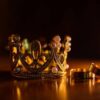 A bejewelled crown and rings, representative of gemstones showing power.