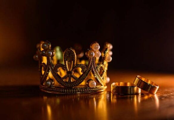 A bejewelled crown and rings, representative of gemstones showing power.