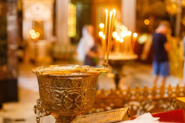 Chalice for olive oil in a religious setting.