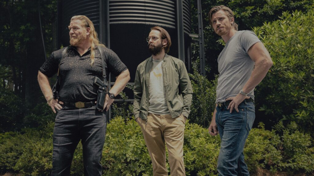 Bodhi and Bigfoot stand looking in the distance in Tulsa King season 3