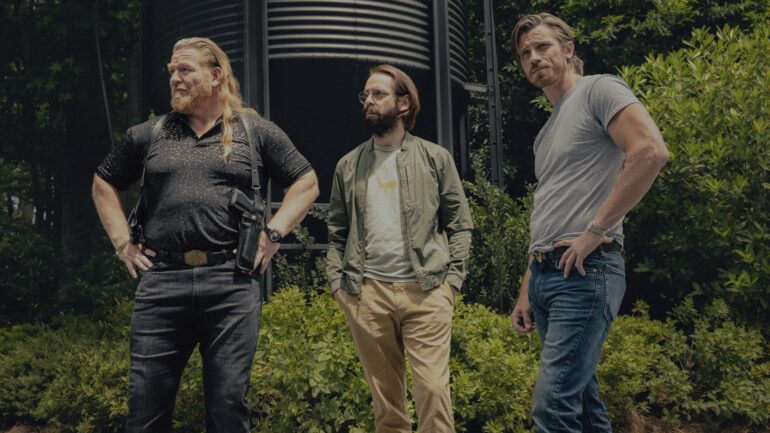 Bodhi and Bigfoot stand looking in the distance in Tulsa King season 3