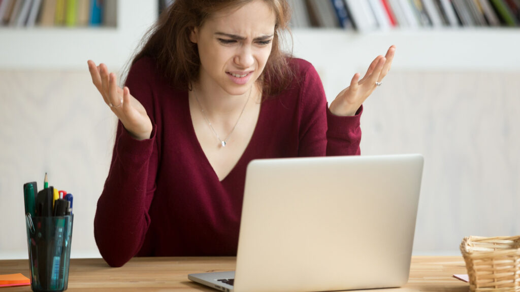 A woman getting frustrated by her Windows laptop