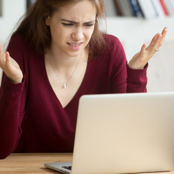 A woman getting frustrated by her Windows laptop