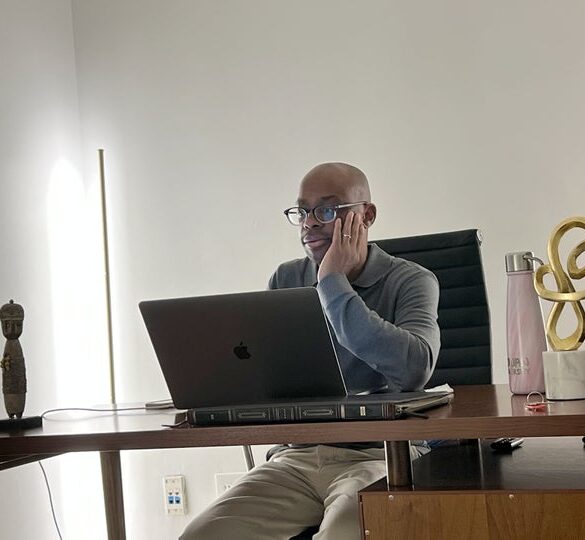 The author in front of a laptop.