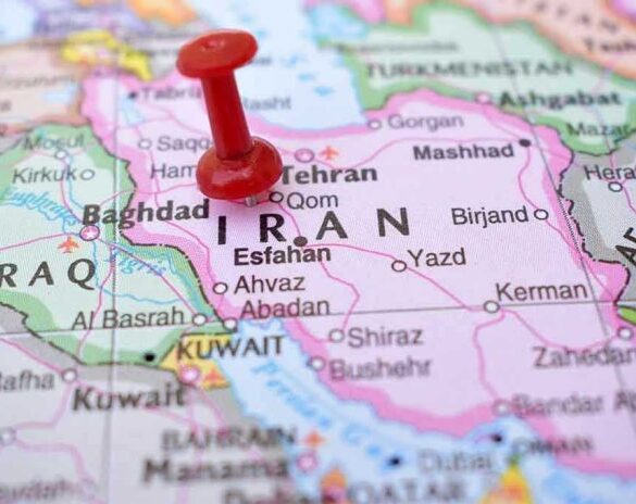 Red pushpin marking Iran on a map.