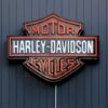 Harley-Davidson Motor Cycles logo on dark wall.