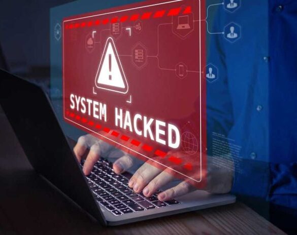 Warning sign System Hacked on laptop screen.
