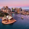 Sydney Opera House and city skyline at sunset.