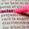 Racist highlighted in pink marker in a book.