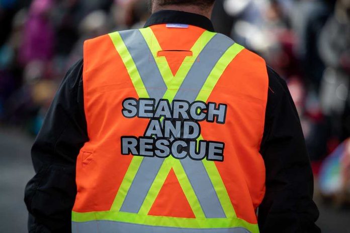 Person wearing a bright orange search and rescue vest