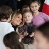 QUANTICO, VIRGINIA - DECEMBER 08: First lady Melania Trump takes photos with children of service members during a Toys for Tots Charity Drive at Marine Corps Base Quantico on December 08, 2025 in Quantico, Virginia. Mrs. Trump delivered remarks to military families and helped children make Christmas cards and sort toys. (Photo by Anna Moneymaker/Getty Images)