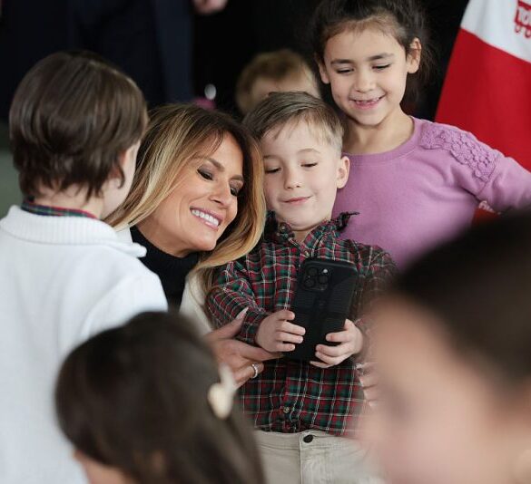 QUANTICO, VIRGINIA - DECEMBER 08: First lady Melania Trump takes photos with children of service members during a Toys for Tots Charity Drive at Marine Corps Base Quantico on December 08, 2025 in Quantico, Virginia. Mrs. Trump delivered remarks to military families and helped children make Christmas cards and sort toys. (Photo by Anna Moneymaker/Getty Images)