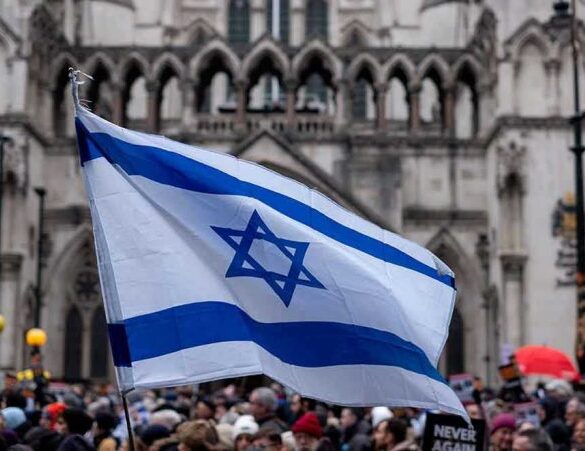 Israeli flag at a crowded outdoor event.