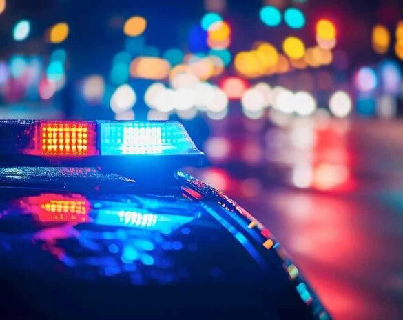 Police car with flashing lights at night.