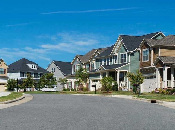 Suburban street with colorful, modern houses.