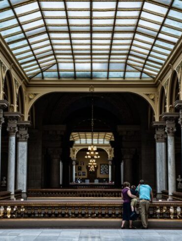 INDIANAPOLIS, IN - JULY 25: A family watches protesters from the top floor of the Indiana State Capitol building on July 25, 2022 in Indianapolis, Indiana. Activists are gathering during a special session of the Indiana state Senate concerning abortion access in the state. (Photo by Jon Cherry/Getty Images)