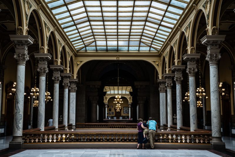 INDIANAPOLIS, IN - JULY 25: A family watches protesters from the top floor of the Indiana State Capitol building on July 25, 2022 in Indianapolis, Indiana. Activists are gathering during a special session of the Indiana state Senate concerning abortion access in the state. (Photo by Jon Cherry/Getty Images)
