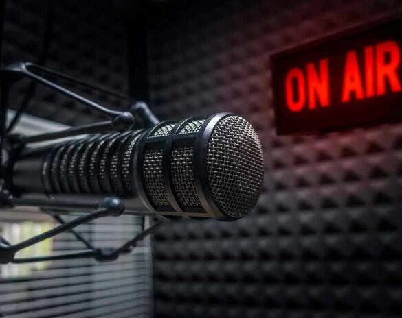 Radio microphone in studio with On Air sign.