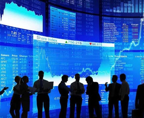Silhouetted business professionals in front of digital stock market displays