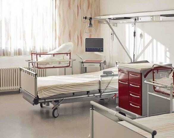 A hospital room featuring empty patient beds and medical equipment