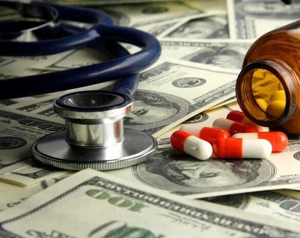 Stethoscope and prescription pills on a background of dollar bills