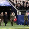 US President Donald Trump waves as he arrives on the field before the college football game between the US Army and Navy at the M&T Bank Stadium in Baltimore, Maryland, on December 13, 2025. (Photo by Alex WROBLEWSKI / AFP via Getty Images)