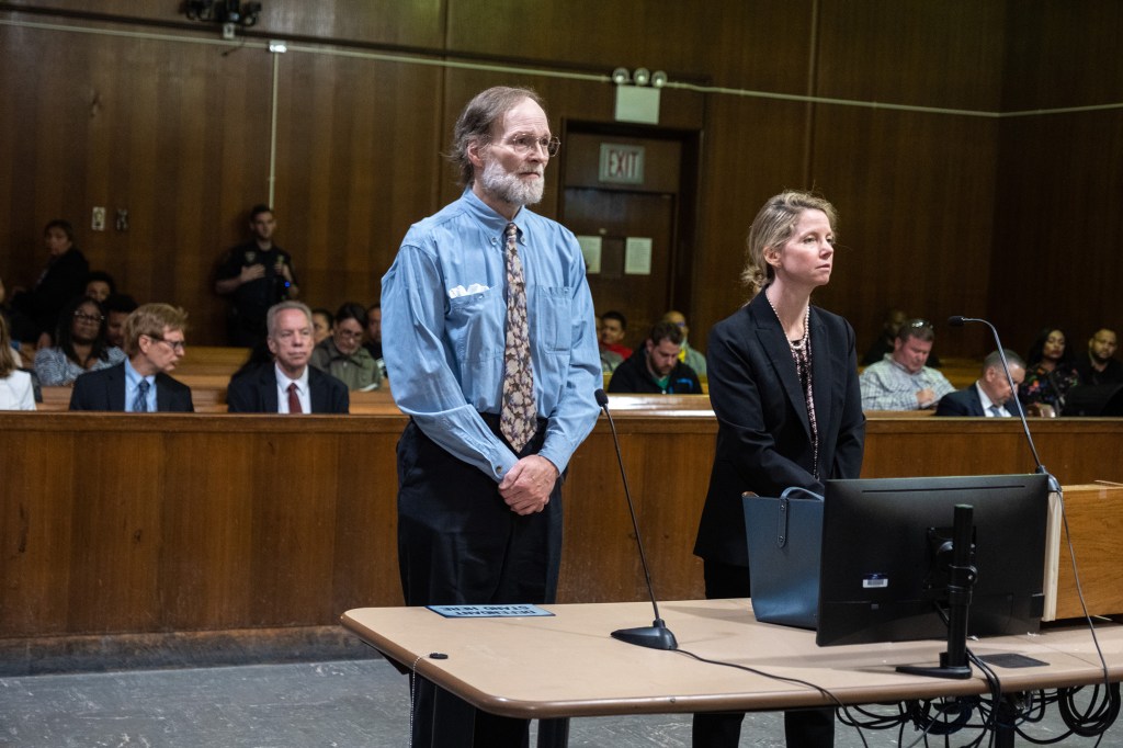 Charles Foehner standing in court next to a woman in a black suit.