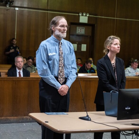 Charles Foehner standing in court next to a woman in a black suit.
