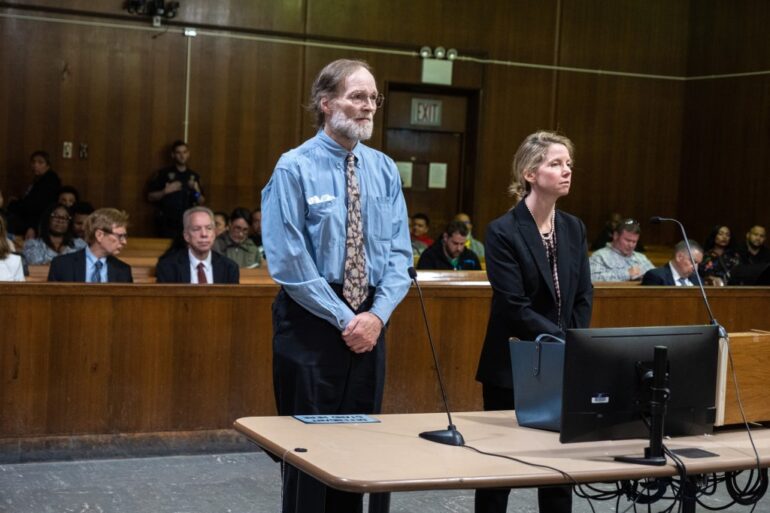Charles Foehner standing in court next to a woman in a black suit.