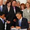 President Obama signing the Affordable Care Act into law.