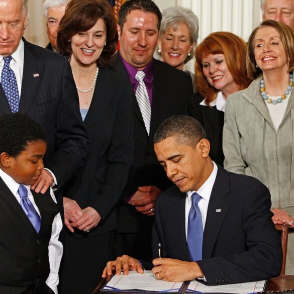 President Obama signing the Affordable Care Act into law.