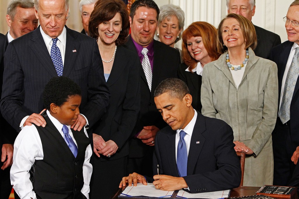 President Obama signing the Affordable Care Act into law.