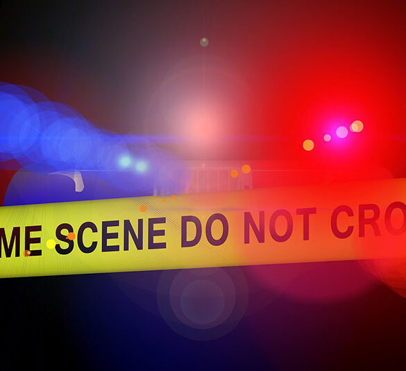 Crime scene police tape in front of blue and red police lights at night. Image by Gerd Altmann